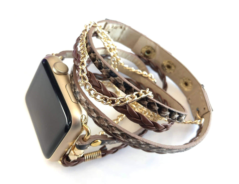 The Boho watch band features three straps on each side of your watch that wrap around the wrist creating the perfect boho style. The three straps include one faux braided leather strap, one gold chain, and one snake print faux leather strap. This boho band has a one size fits all connector fitting watch sizes 38/40/42/44. This band fits wrist sizes 6.25"-7.5" and closes with three different snaps for your custom size