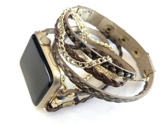 The Boho watch band features three straps on each side of your watch that wrap around the wrist creating the perfect boho style. The three straps include one faux braided leather strap, one gold chain, and one snake print faux leather strap. This boho band has a one size fits all connector fitting watch sizes 38/40/42/44. This band fits wrist sizes 6"-7.5" and closes with three different snaps for your custom size.