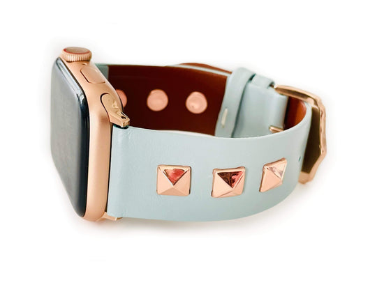 Beautiful MINT BLUE top grain genuine LEATHER, STUDDED Apple Watch Band. This watch band features a stainless steel buckle and is adorned with three metal studs on each side. Stud color choices include Silver, Gold, and Rose Gold. Studs are square shaped and slightly raised in the center giving them a pyramid shape. This watch band fits all series of Apple Watches. Comes in sizes 38/40 and 42/44