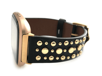 Beautiful black top grain genuine leather studded watch band. This watch band features a stainless steel buckle and is adorned with several flat circular metal studs on each side. Stud color choices include Silver, Gold, and Rose Gold. This watch band features a quick release spring bar and is a perfect fit for the Fitbit Versa watch.