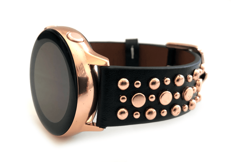 Beautiful black top grain genuine leather studded watch band. This watch band features a stainless steel buckle and is adorned with several flat circular metal studs on each side. Stud color choices include Silver, Gold, and Rose Gold. This watch band features a quick release spring bar and is a perfect fit for the Samsung watch. 