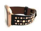 Beautiful black top grain genuine leather studded watch band. This watch band features a stainless steel buckle and is adorned with several flat circular metal studs on each side. Stud color choices include Silver, Gold, and Rose Gold. This watch band features a quick release spring bar and is a perfect fit for the Fitbit Versa watch.