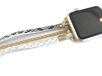 The Boho watch band features three straps on each side of your watch that wrap around the wrist creating the perfect boho style. The three straps include one faux braided leather strap, one gold chain, and one snake print faux leather strap. This boho band has a one size fits all connector fitting watch sizes 38/40/42/44. This band fits wrist sizes 6.25"-7.5" and closes with three different snaps for your custom size.