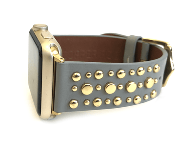 Beautiful GREY top grain genuine LEATHER, STUDDED Apple Watch Band. This watch band features a stainless steel buckle and is adorned with several flat circular studs. Stud color choices include Silver, Gold, and Rose Gold.  This watch band fits all series of Apple Watches. Comes in sizes 38/40 and 42/44
