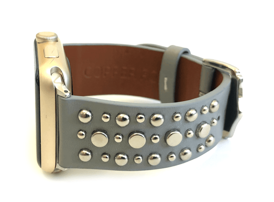 Beautiful GREY top grain genuine LEATHER, STUDDED Apple Watch Band. This watch band features a stainless steel buckle and is adorned with several flat circular studs. Stud color choices include Silver, Gold, and Rose Gold.  This watch band fits all series of Apple Watches. Comes in sizes 38/40 and 42/44