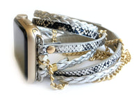 The Boho watch band features three straps on each side of your watch that wrap around the wrist creating the perfect boho style. The three straps include one faux braided leather strap, one gold chain, and one snake print faux leather strap. This boho band has a one size fits all connector fitting watch sizes 38/40/42/44. This band fits wrist sizes 6"-7.5" and closes with three different snaps for your custom size.