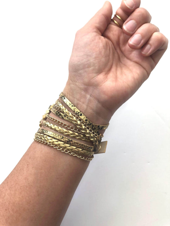 The Boho watch band features three straps on each side of your watch that wrap around the wrist creating the perfect boho style. The three straps include one faux braided leather strap, one gold chain, and one snake print faux leather strap. This boho band has a one size fits all connector fitting watch sizes 38/40/42/44. This band fits wrist sizes 6"-7.5" and closes with three different snaps for your custom size.