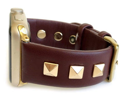 Beautiful BURGUNDY top grain genuine LEATHER, STUDDED Apple Watch Band. This watch band features a stainless steel buckle and is adorned with three metal studs on each side. Stud color choices include Silver, Gold, and Rose Gold.  This watch band fits all series of Apple Watches. Comes in sizes 38/40 and 42/44