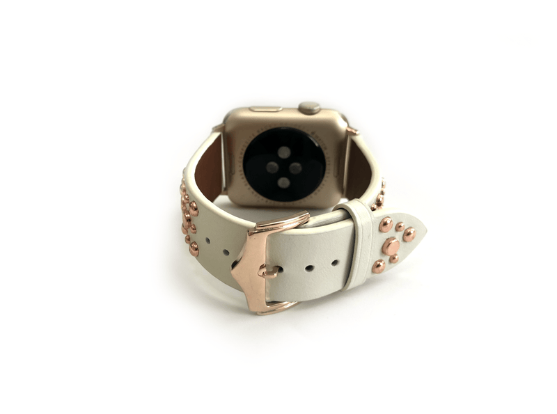 Beautiful WHITE top grain genuine LEATHER, STUDDED Apple Watch Band. This watch band features a stainless steel buckle and is adorned with several flat circular studs. Stud color choices include Silver, Gold, and Rose Gold.  This watch band fits all series of Apple Watches. Comes in sizes 38/40 and 42/44