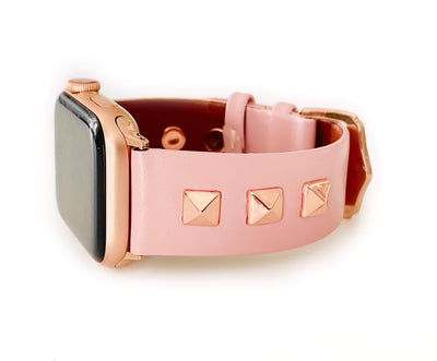 Beautiful PINK top grain genuine LEATHER, STUDDED Apple Watch Band. This watch band features a stainless steel buckle and is adorned with three metal studs on each side. Stud color choices include Silver, Gold, and Rose Gold. Studs are square shaped and slightly raised in the center giving them a pyramid shape. This watch band fits all series of Apple Watches. Comes in sizes 38/40 and 42/44