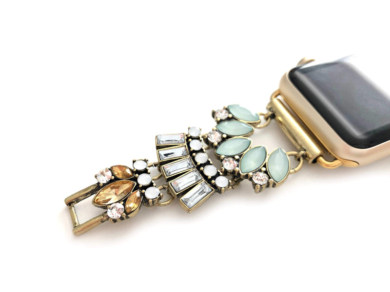 Gold jeweled apple watch band with mint, clear, opal and amber glass crystals. All crystals paced in an unique 1920 inspired pattern that lead to size adjustable clasps. This beautiful band fits all series of apple watches in sizes 38, 40, 42, and 44