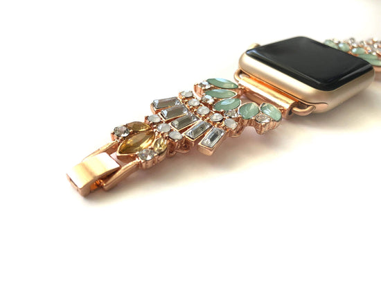 Gold jeweled apple watch band with mint, clear, opal and amber glass crystals. All crystals paced in an unique 1920 inspired pattern that lead to size adjustable clasps. This beautiful band fits all series of apple watches in sizes 38, 40, 42, and 44