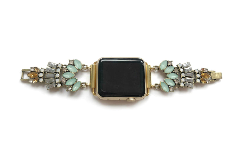 Gold jeweled apple watch band with mint, clear, opal and amber glass crystals. All crystals paced in an unique 1920 inspired pattern that lead to size adjustable clasps. This beautiful band fits all series of apple watches in sizes 38, 40, 42, and 44